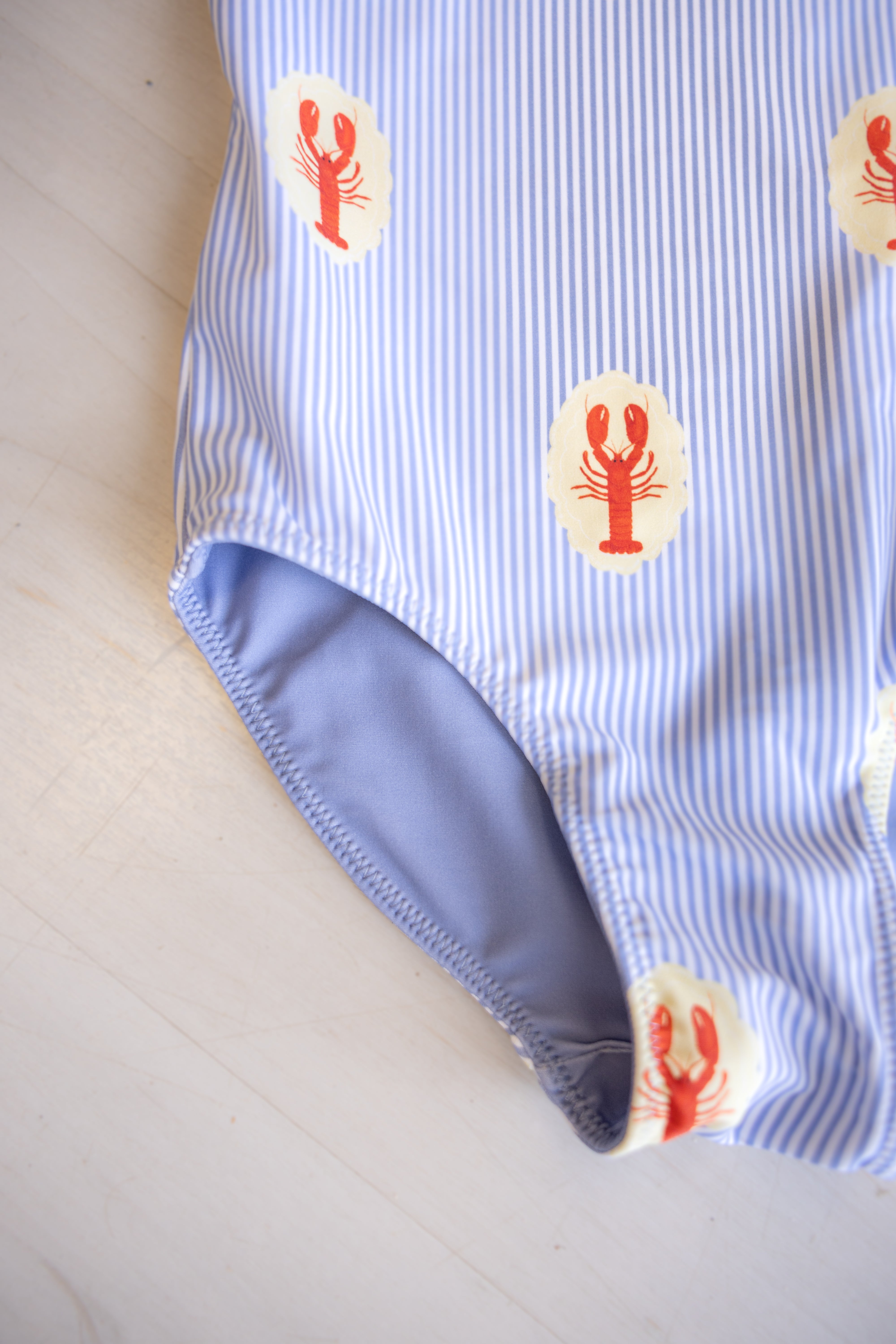 GIRLS' MUST-HAVE: PREORDER THE COURTNEY BLUE LOBSTER MEDALLION ONE-PIECE SWIMSUIT NOW!